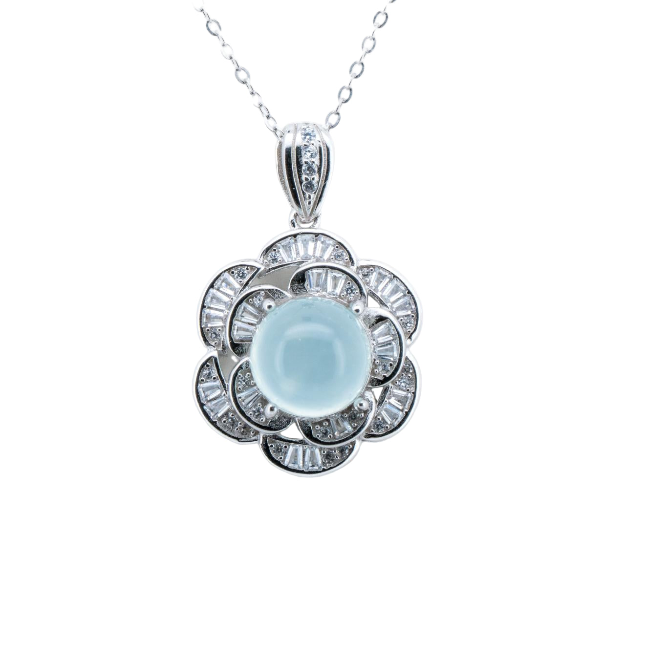 Silver pendant with a central blue gemstone on a white background