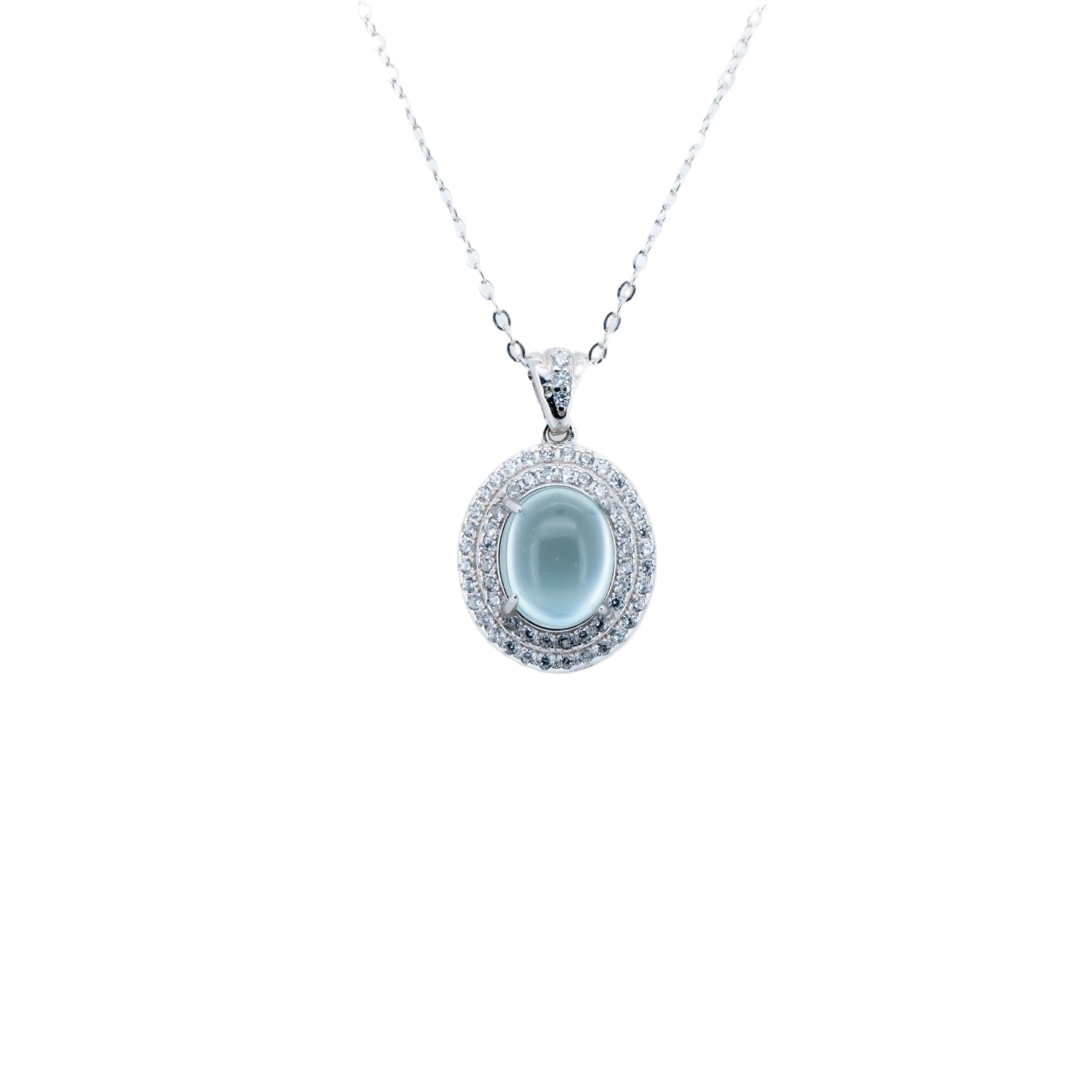 Silver pendant necklace with a central gemstone on a white background