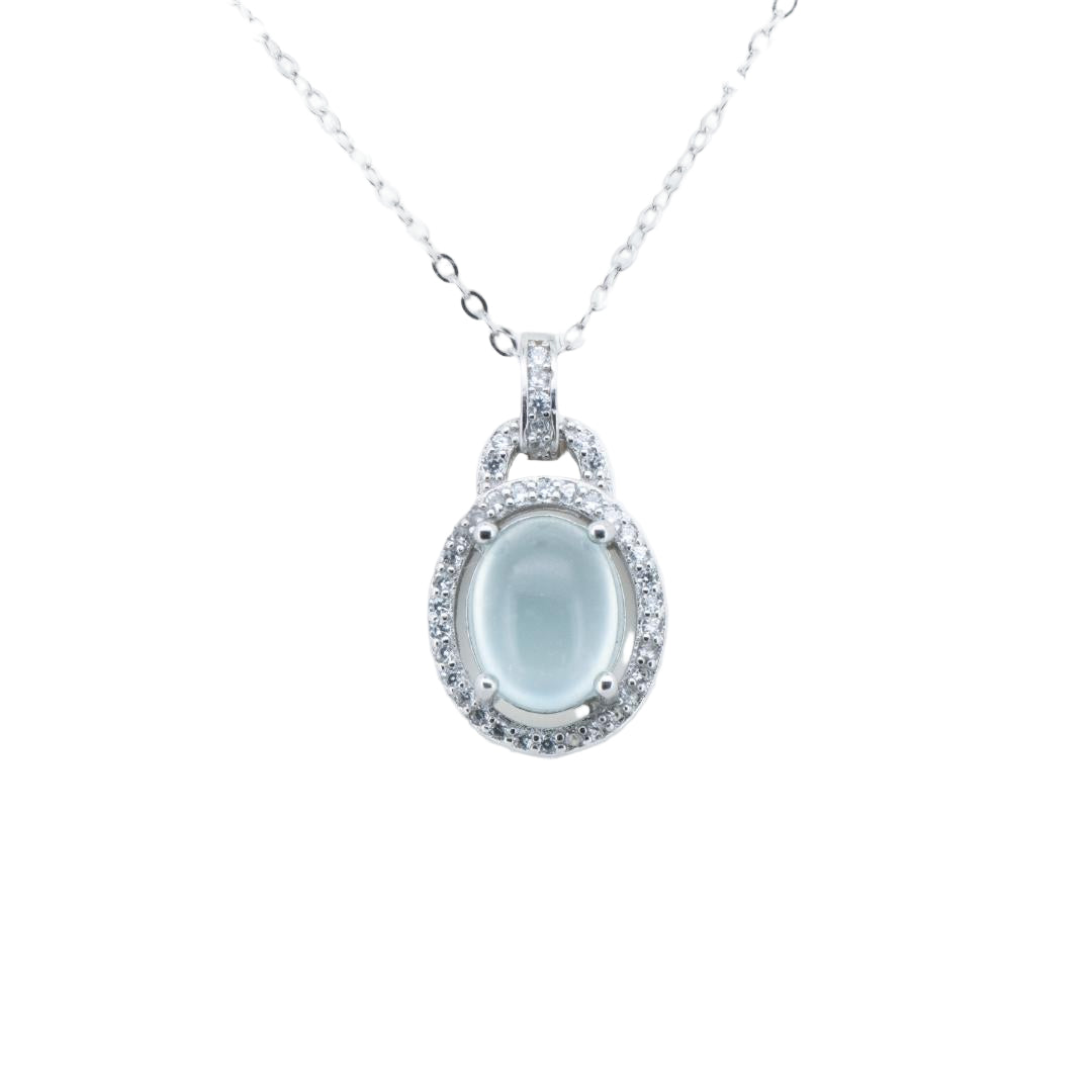 Silver necklace with a pendant featuring a blue gemstone on a white background