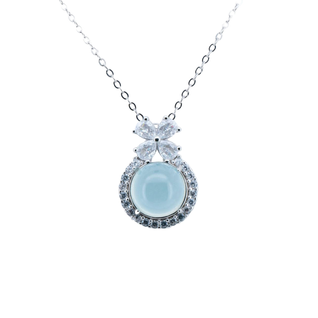 Necklace with a light blue pendant and clear stones on a white background