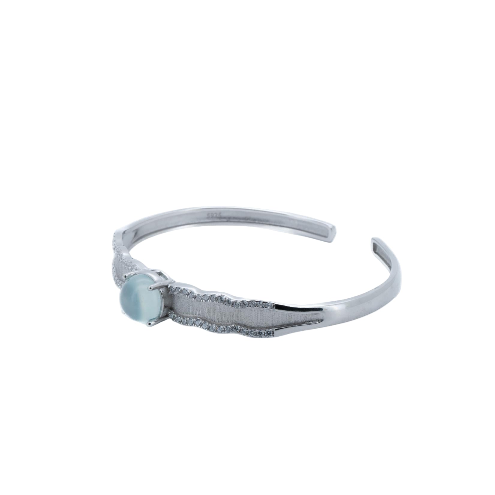 Silver bracelet with a small round gemstone on a white background